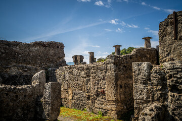 Ruins of ancient city of Pompeii, ancient roman city against Vesuvius volcano at sunset, Italy