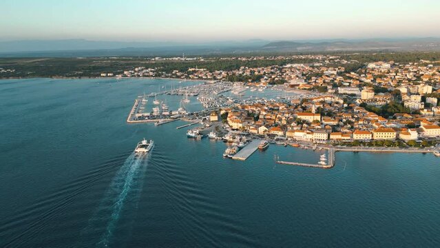 Biograd na Moru, marina aerial view with beach, sailing boats and luxury yachts in port. Historic Old Town architecture, summer clear sky and blue waters of Adriatic Sea in Dalmatia region of Croatia