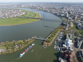 Aerial view over Dusseldorf, seen from the media harbor. Ship traffic on rhine river. Tv tower, rhein turm and bridges.