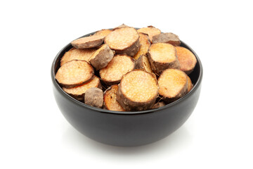 Close-up of Dry Organic Indian root fruit 'Kandmool' (Agave Americana), in black ceramic bowl. Isolated on a white background.