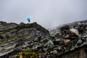 Person with Blue Umbrella on Rocky Mountain