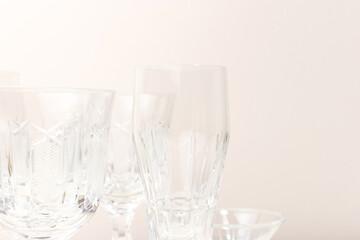 Crystal glasses in front of beige background. Place for text.