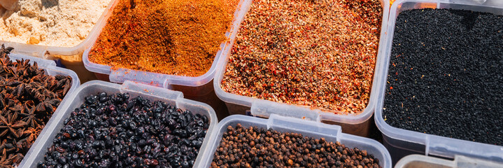 assortment of various oriental spices on the counter at the Asian Uzbek bazaar in close-up