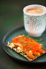 Avocado, salted salmon, egg and red caviar rye crisp toast