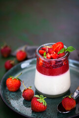 Delicious Italian dessert Panna Cotta with fresh summer strawberries