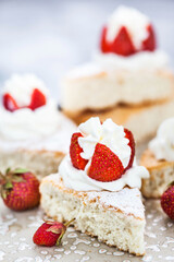 Pieces of White Angel cake, decorated with whipped cream and fresh strawberries