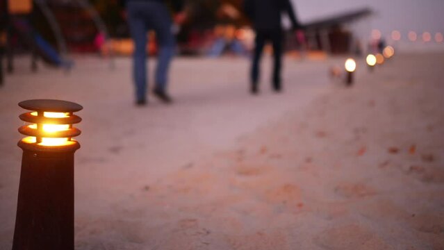 Lighted lantern on background of people walking