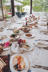 a beautifully decorated table with delicious food. Everything is ready for lunch or dinner with delicious snacks and a cozy atmosphere. Serving a holiday table with fish dishes, salads and snacks.