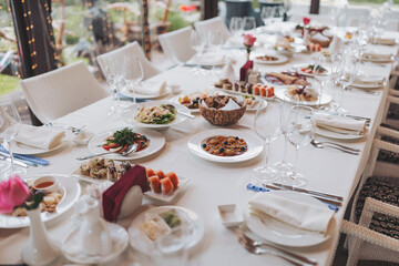 a beautifully decorated table with delicious food. Everything is ready for lunch or dinner with delicious snacks and a cozy atmosphere. Serving a holiday table with fish dishes, salads and snacks.