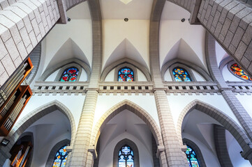 Sacred Heart of Jesus Cathedral in Tashkent in Uzbekistan. Interior of a ancient Catholic church with stained glass windows