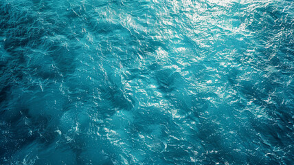 Aerial view of a turquoise, calm and crystal clear ocean. Blue water background in summertime