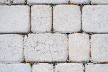 texture of white stone paving slabs on the sidewalk close-up