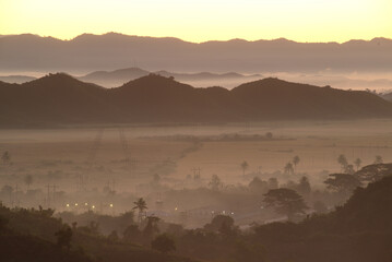 Obraz premium Evening view on top of the mountain at Rattanabun Chedi view point and gentle light In the valley there was a long mist. Located at Mrauk-U city, Myanmar.