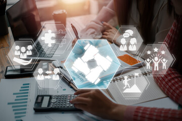 Working together concept, Business team analyzing income charts and graphs on office desk with Working together icon on virtual screen.