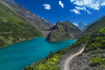 Fototapeta premium Lake with blue clear clear water in the mountains in summer. Koksai Ainakol Lake in Tien Shan Mountains in Asia in Kazakhstan