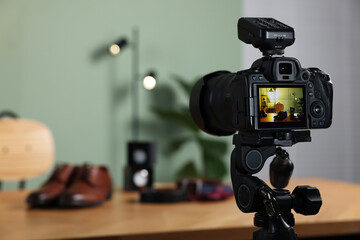 Beauty blogger's workplace. Men's accessories on table indoors, focus on camera