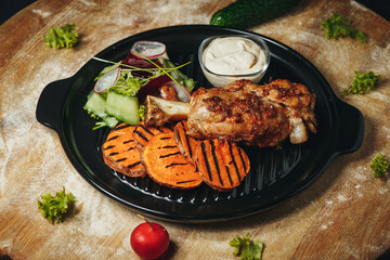 A Culinary Masterpiece: Chicken, Sweet Potatoes, and Vegetables on a Plate