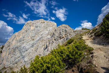 Dolomites mountains, Alpi Dolomiti beautiful scenic landscape in summer. Italian Alps mountain summits and rocky peaks above green valley alpine scene