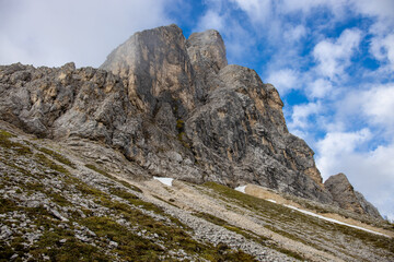 Dolomites mountains, Alpi Dolomiti beautiful scenic landscape in summer. Italian Alps mountain summits and rocky peaks above green valley alpine scene