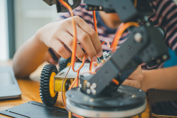 Asian boy learning and studying the work of technology robots.homeschool and science for tech project. playing childhood kids hobby leisure lifestyle people toys robotics technology.