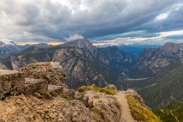 Dolomites mountains, Alpi Dolomiti beautiful scenic landscape in summer. Italian Alps mountain summits and rocky peaks above green valley alpine scene