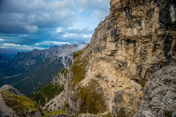 Dolomites mountains, Alpi Dolomiti beautiful scenic landscape in summer. Italian Alps mountain summits and rocky peaks above green valley alpine scene