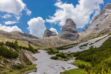 Dolomites mountains, Alpi Dolomiti beautiful scenic landscape in summer. Italian Alps mountain summits and rocky peaks above green valley alpine scene