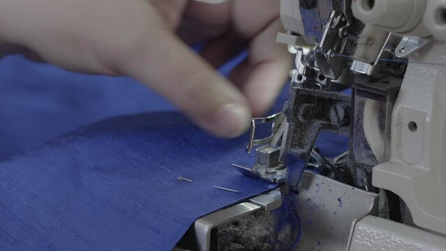 Woman sewing on a sewing machine overlock