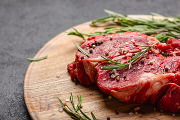 Raw beef meat on a wooden tray