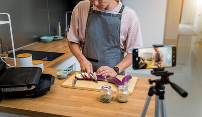 The chef is broadcasting live from workshop how to prepare a grilled eggplants with garlic