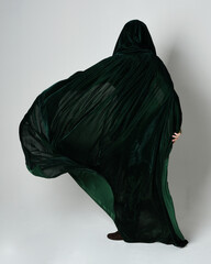 Full length portrait of red haired female model, wearing green medieval fantasy costume, long...
