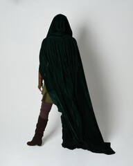 Full length portrait of red haired female model, wearing green medieval fantasy costume, long...