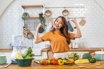 Portrait of beauty body slim healthy asian woman eating vegan food healthy with fresh vegetable salad in kitchen at home.diet, vegetarian, fruit, wellness, health, green food.Fitness and healthy food