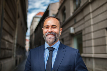 Portrait of a smiling businessman standing in the city