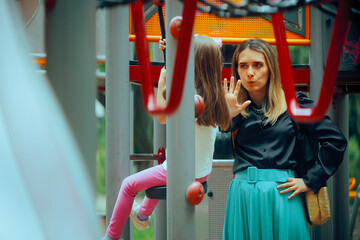 Mother Saying Stop to her Daughter at the Playground. Unhappy mom scolding her daughter being...