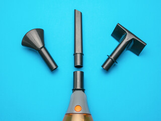 Assortment of Vacuum Cleaner Attachments on a Blue Background for Home Cleaning