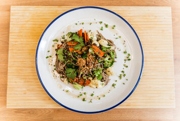 Japanese buckwheat pasta with lentils and vegetables in a bowl