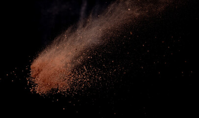 Brick Sand flying explosion,  Abstract cloud fly. Orange colored sand splash throwing in air on black background