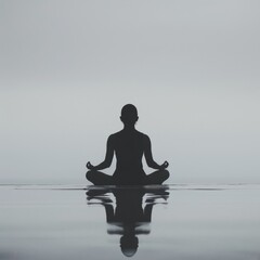 Silhouette of a person meditating on calm waters, reflecting peacefulness and tranquility in a serene natural setting.