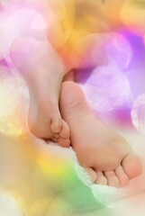 Bedding, warm fluffy blanket and colorful blurred sweet flare light. Bare foot , happy time for...