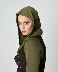 Close up portrait of beautiful red haired female model, wearing green and brown medieval fantasy...