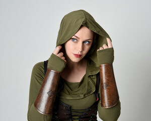 Close up portrait of beautiful red haired female model, wearing green and brown medieval fantasy...