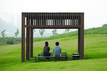 View of the couple sitting on the bench