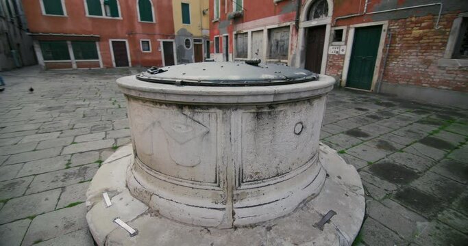 Beautiful architecture of Campo de Pozzi, Venice, Italy. A well in the city square on the canals. Romantic and touristic cityscape. High quality 4k footage