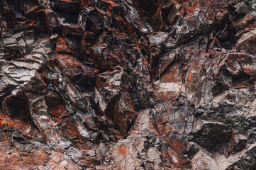 texture of an orange stone mountain with natural minerals in close-up