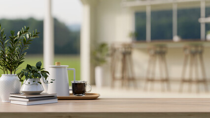 A wooden tabletop features a coffee set, books, and potted plants in a contemporary outdoor lounge.