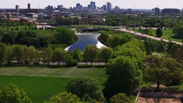 Highangle view of James S. McDonnell Planetarium and its unique structure, and the St Louis skyline in the background, transitioning through the landscape