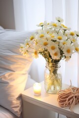 A white vase with yellow flowers sits on a nightstand next to a lamp. The scene is peaceful and calming, with the flowers adding a touch of natural beauty to the room