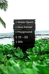 Wooden sign path with words and direction and sea background