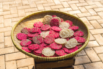 Closeup photo of sun dried Indonesian crackers made from dried rice called Renginang or Ranginang on bamboo tray